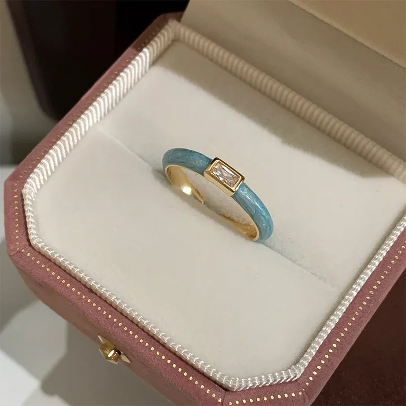 Gold ring with a blue band in a jewelry box