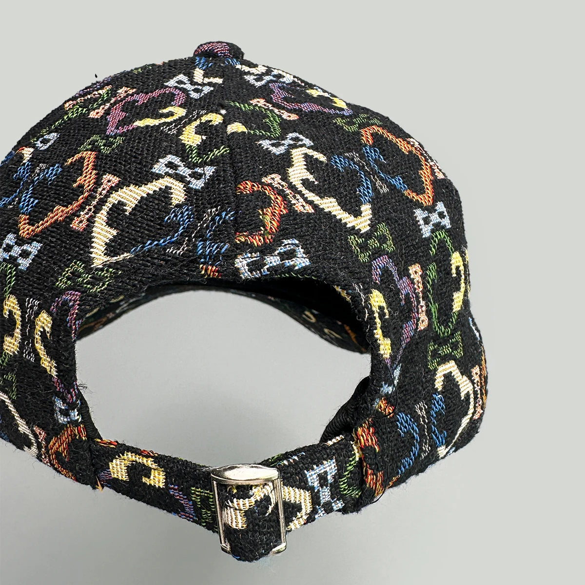 Multicolored patterned cap on a gray background back strap