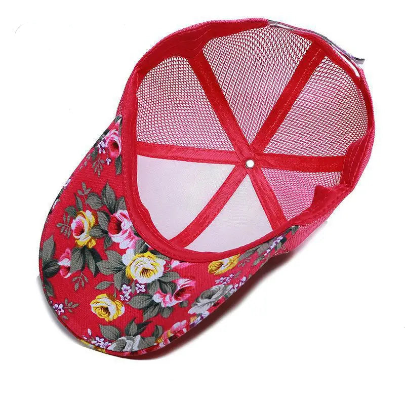 Red floral-patterned cap with a mesh back on a white background