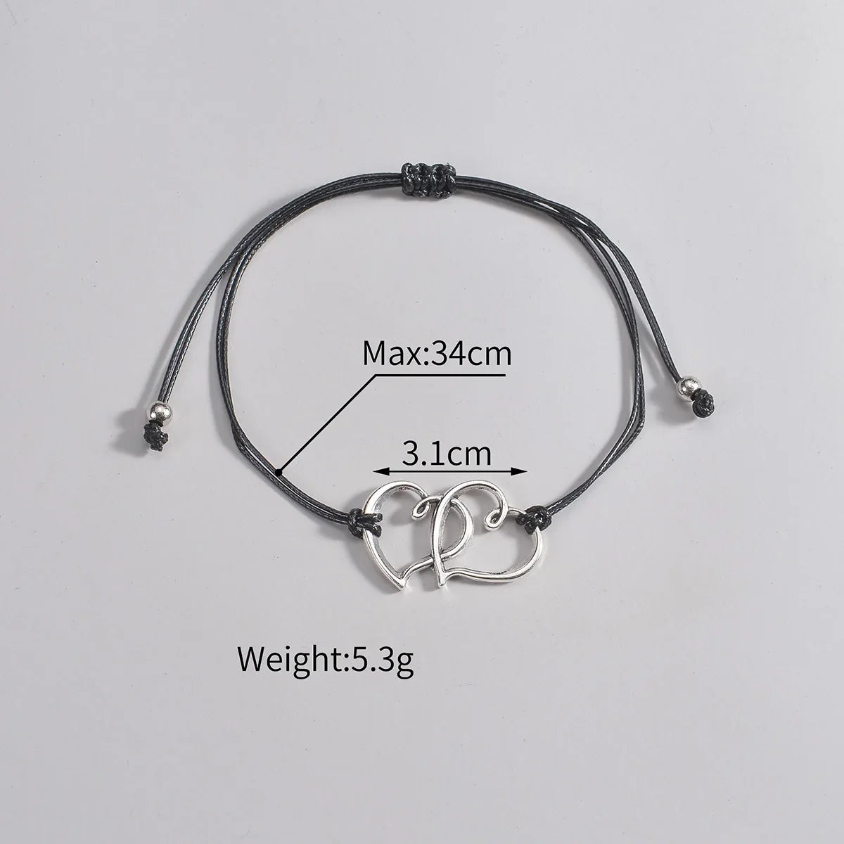 Bracelet for ankle with heart-shaped charms and measurement details on a gray background