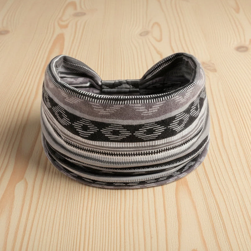Black and gray patterned headband on a wooden surface