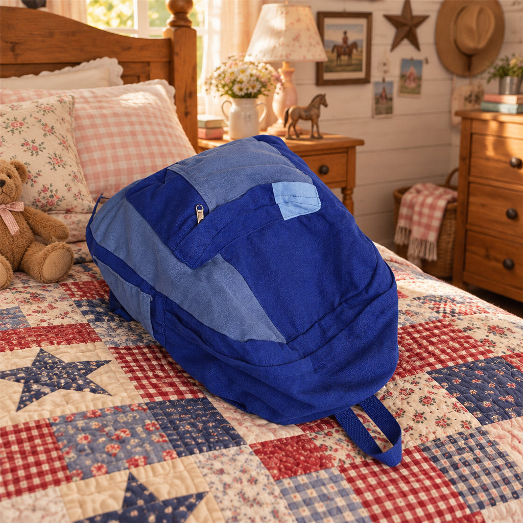 Blue backpack on a quilt.