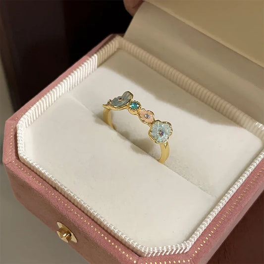Gold ring with gemstones in a pink jewelry box