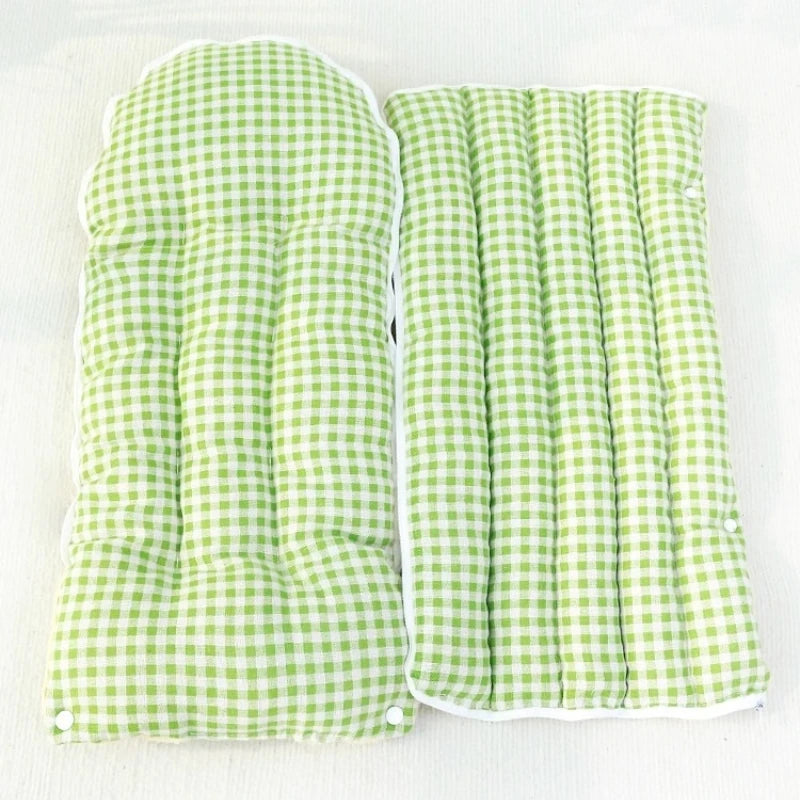 Green checkered  cat bed pads on a white background