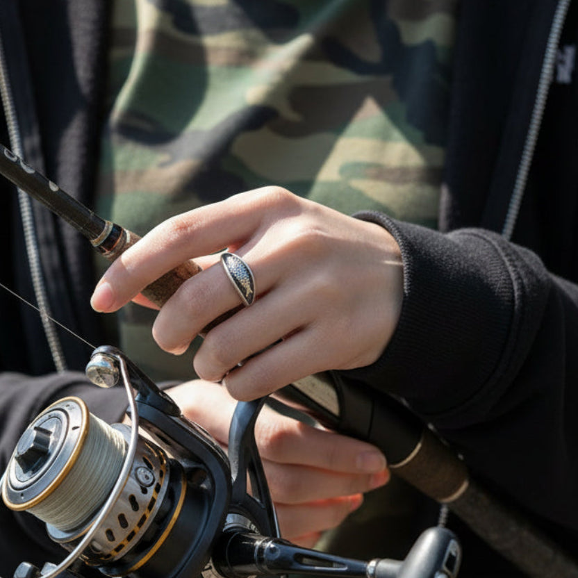 Person holding a fishing rod with a blurred natural background