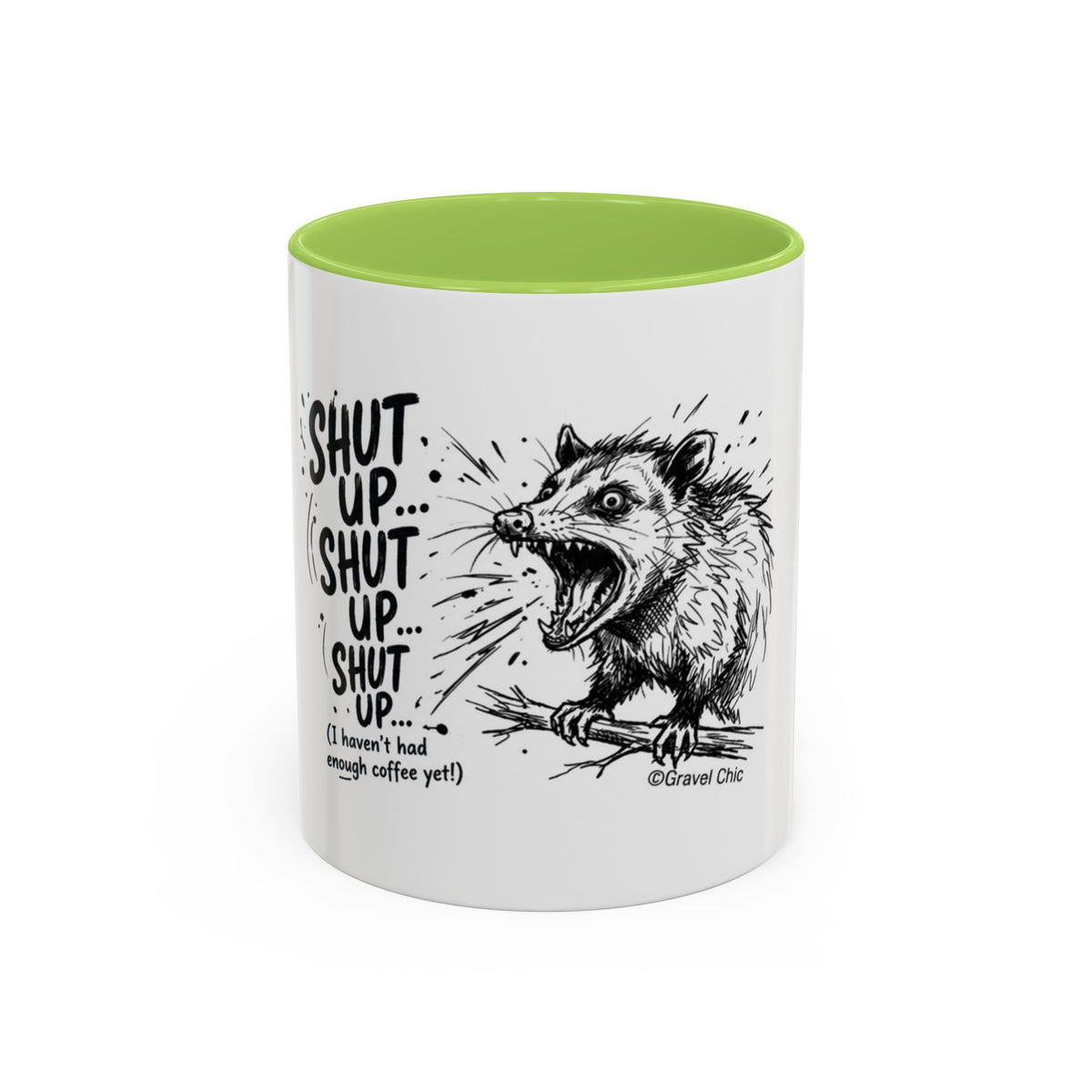 A white ceramic mug with a bright green interior, featuring a black line art illustration of a shouting opossum and the text 'SHUT UP