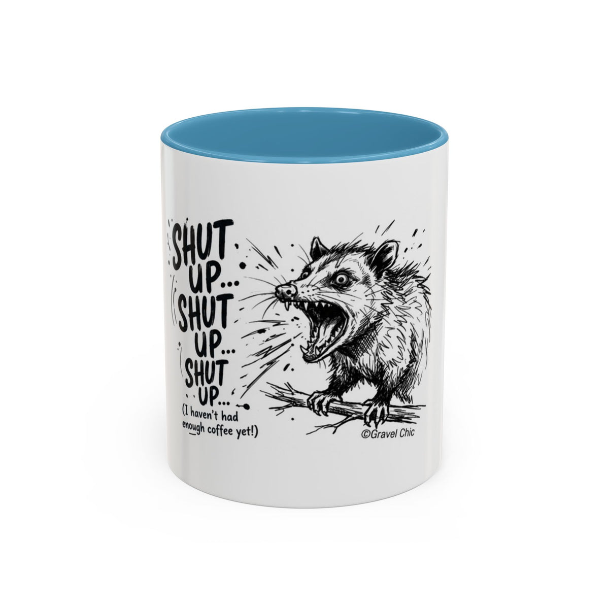 A white ceramic mug with a bright blue interior, featuring a black line art illustration of a screaming possum and the text 'SHUT UP.
