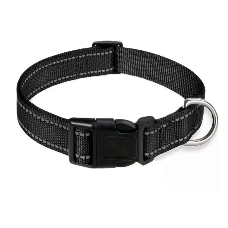 Black dog collar with a metal leash loop on a white background