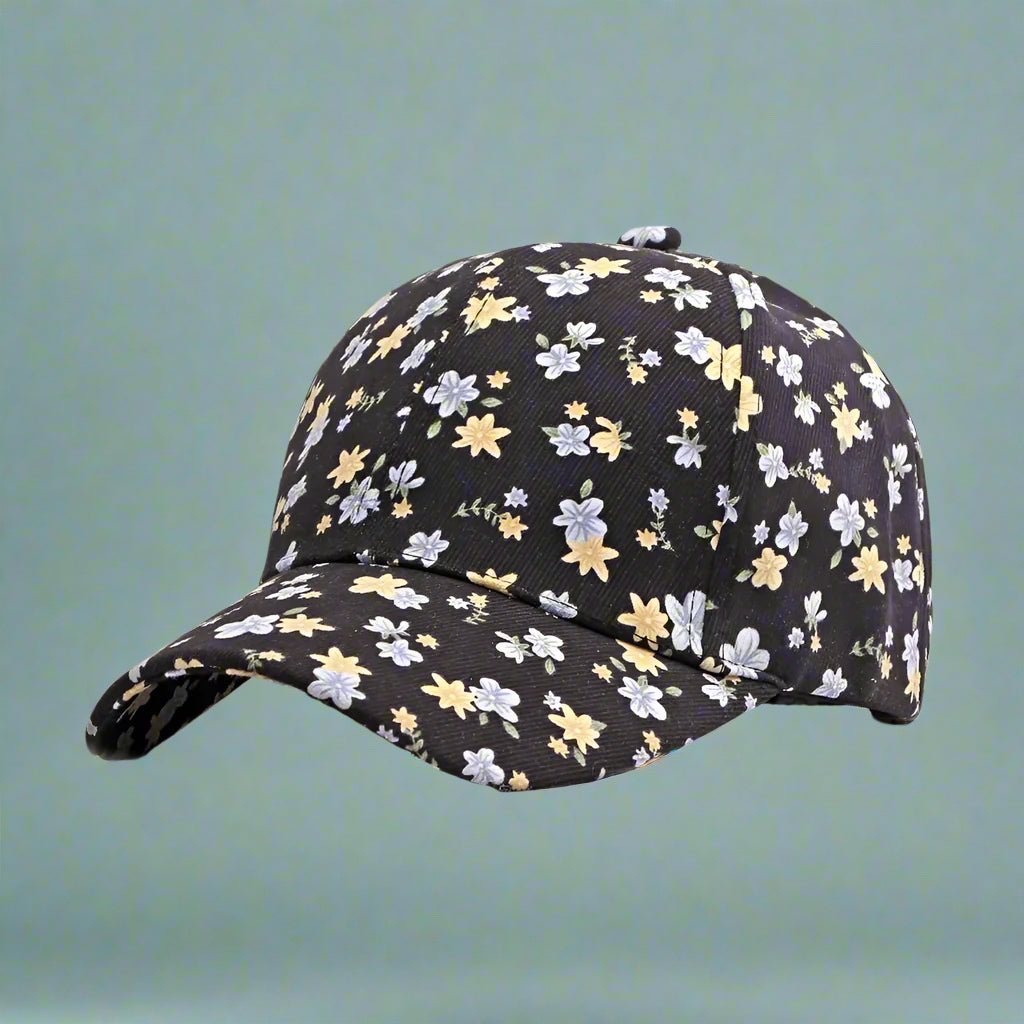 black hat with blue and yellow ditsy floral pattern on a light blue, green background