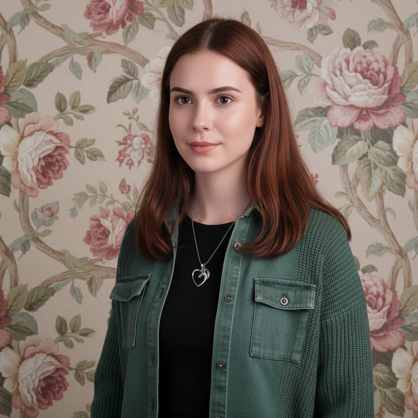 Woman wearing a horse necklace and a green jacket with floral wallpaper background