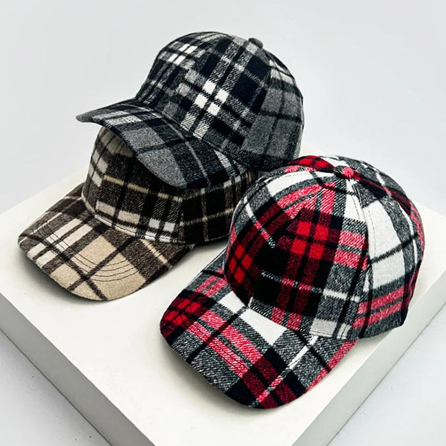 Three plaid baseball caps-trucker hats on a white surface with a light gray background.