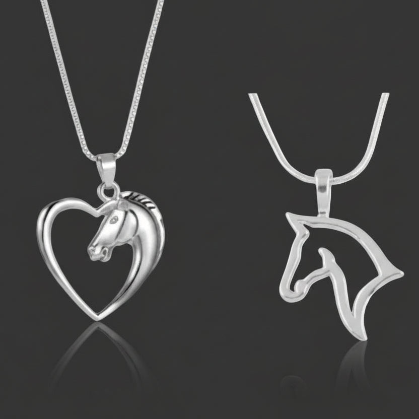 Two silver horse pendants on a black background