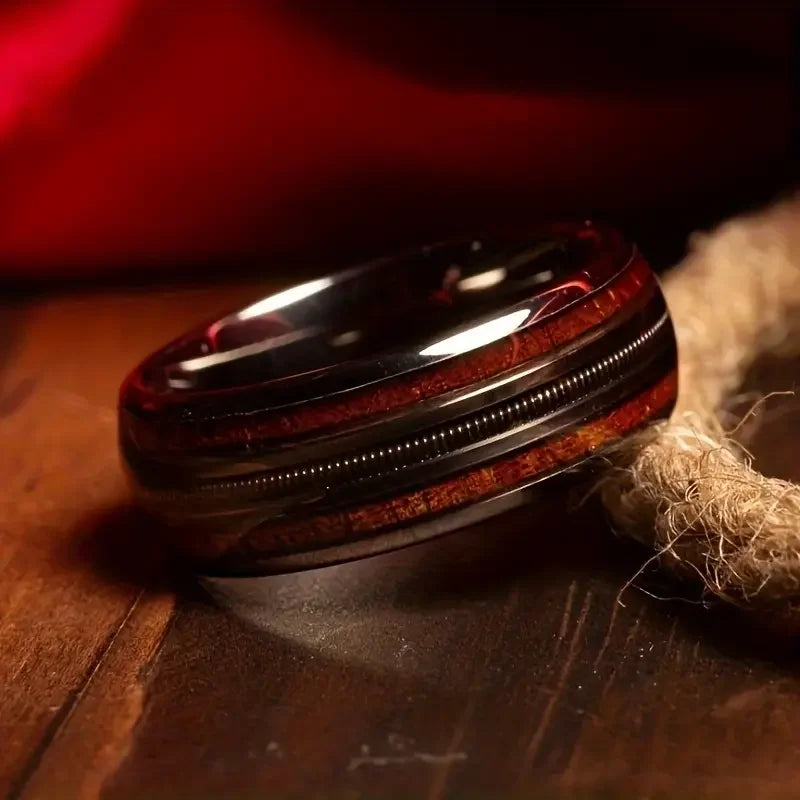 Wooden ring with metal band on a rustic rope on a surface