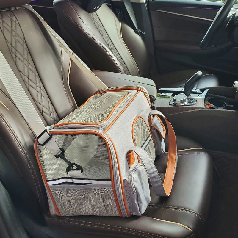 Pet carrier on a car seat with a visible steering wheel and dashboard in the background