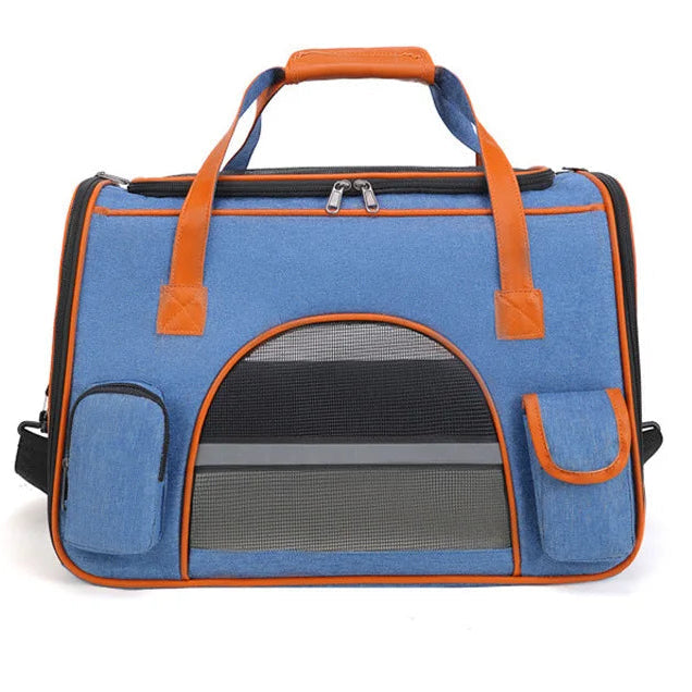 Blue pet carrier with leather-like accents on a white background