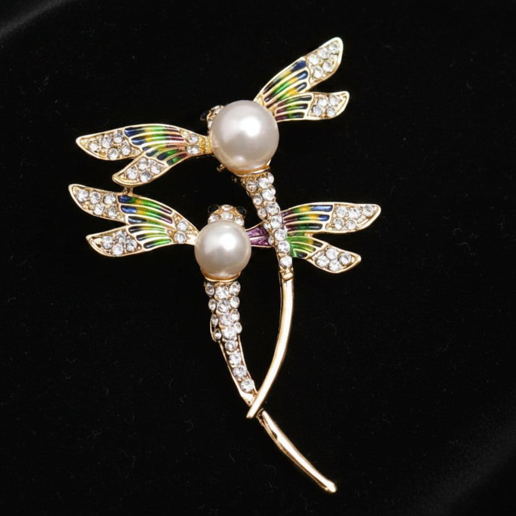 brooch depicting two dragonflies on black velvet