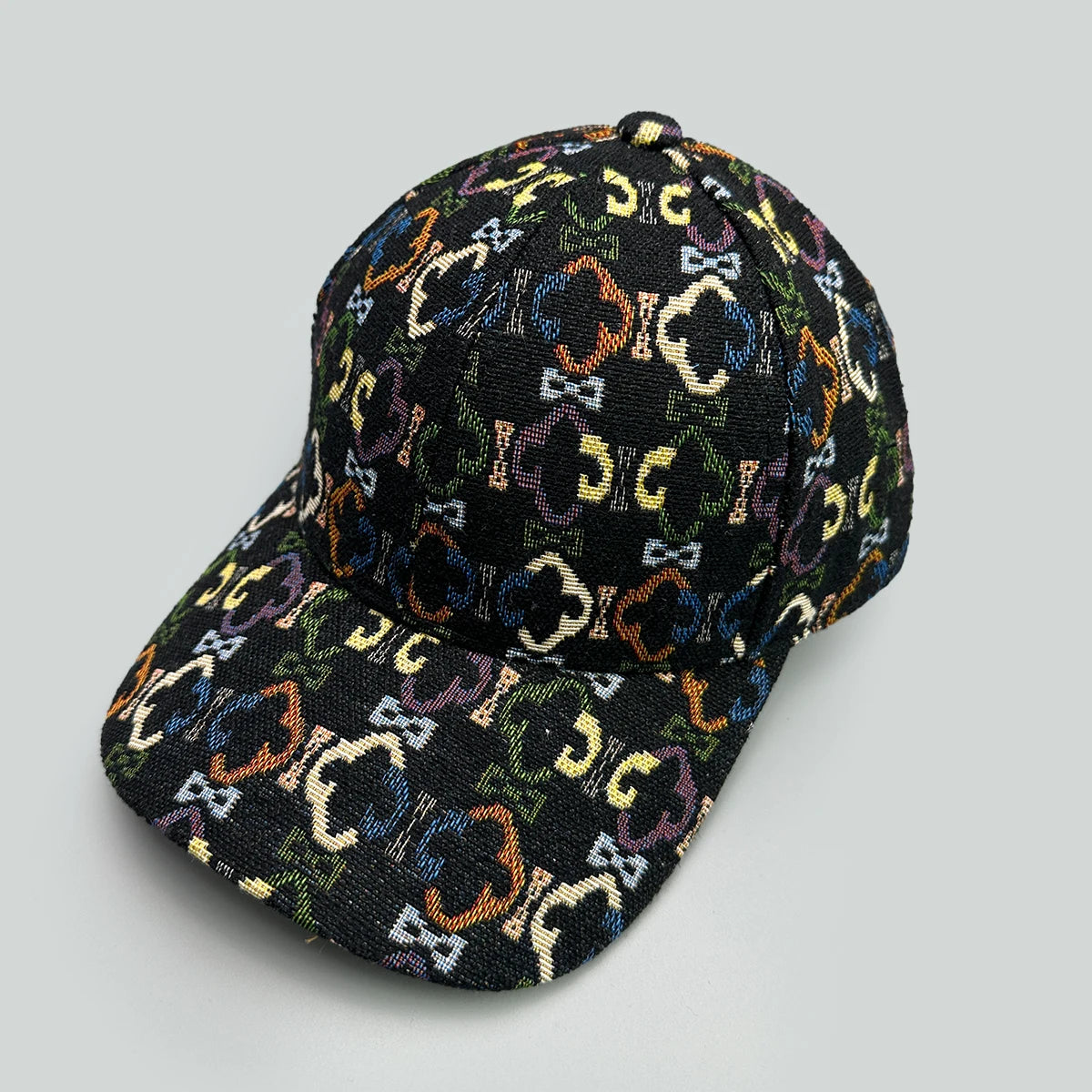Black cap with colorful geometric pattern on a gray background