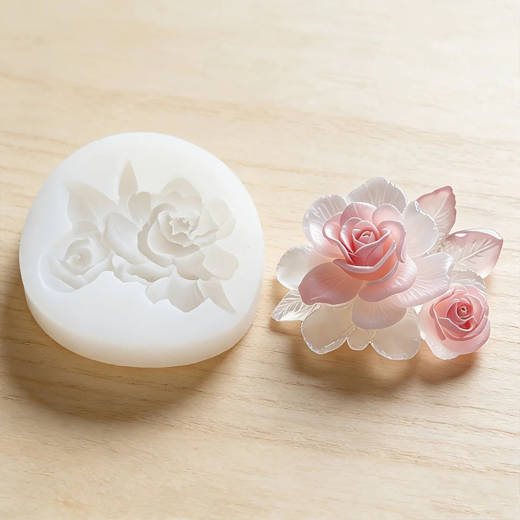 Silicone mold with rose design next to a pink rose on a light wooden surface