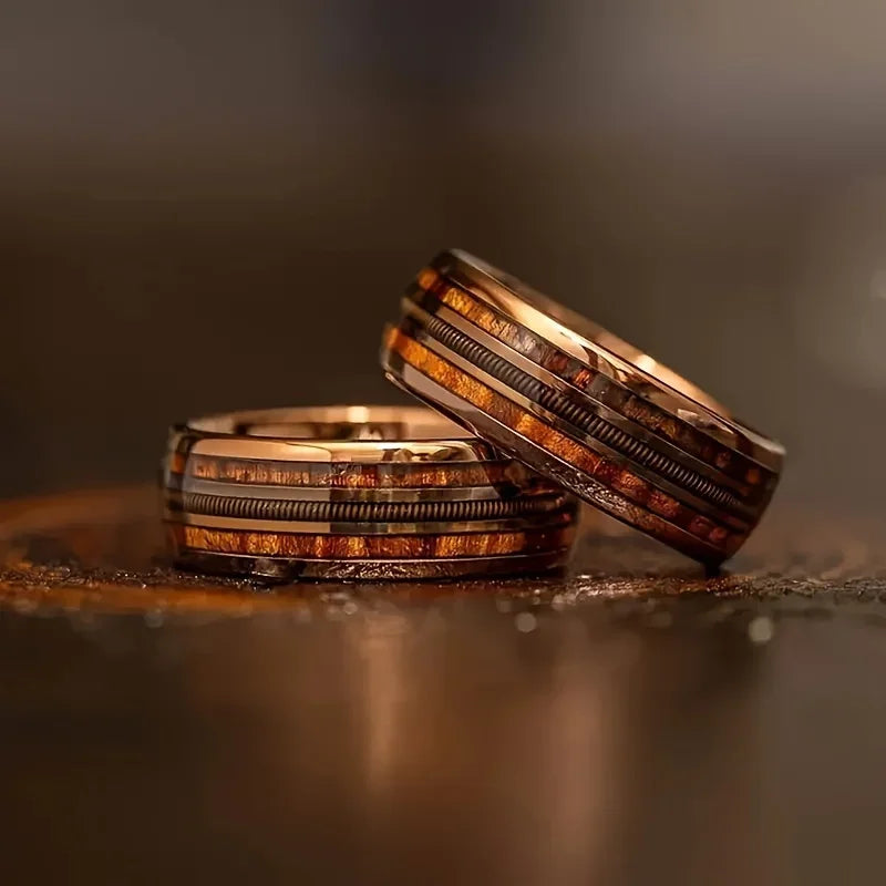 Two rings stacked on a reflective surface with a blurred background
