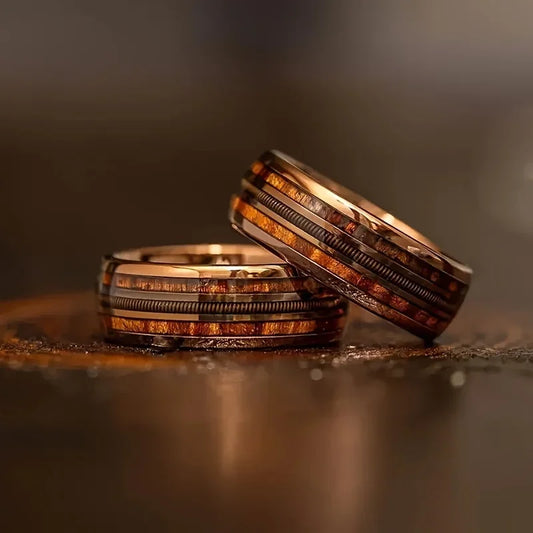 Two rings stacked on a reflective surface with a blurred background